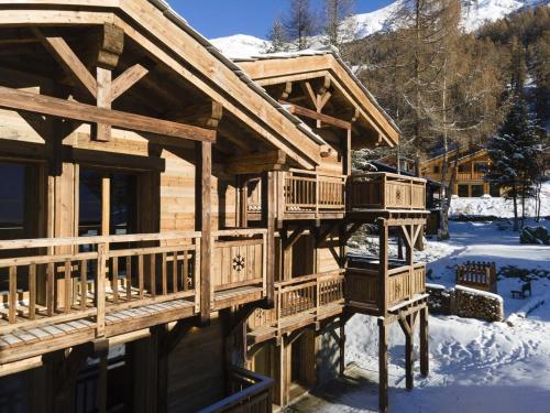 a large wooden house with snow on the ground at Polaris 1 005 - LUXE & SKI LIFT apartment 6 pers in Zinal