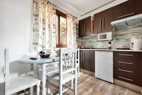 a kitchen with a table and chairs in a kitchen at La Casita Canaria y Lagar in Los Silos