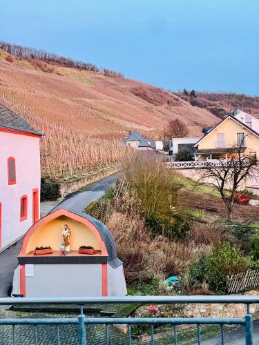 a toy figure sitting on top of a building next to a road at Ferienweingut Reh in Klüsserath in Klüsserath