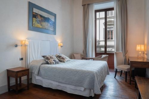 フィレンツェにあるIl Salotto Di Firenzeのベッドルーム1室(ベッド1台、デスク、窓付)