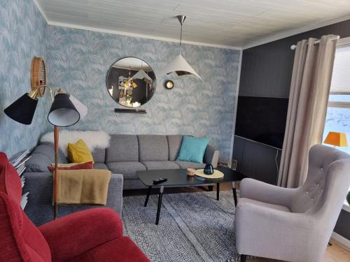a living room with a couch and a table at T-R Huset i Hellosan in Bøstad