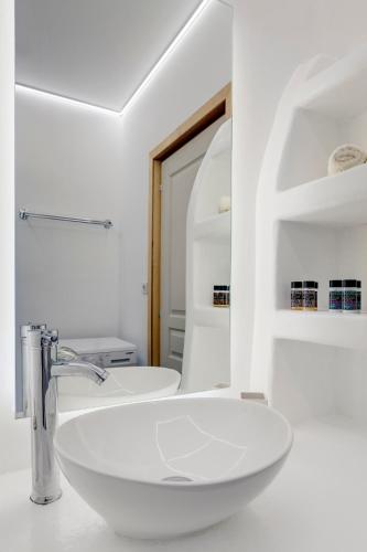 a white bathroom with a sink and a mirror at Endless Blue from Syros - Vari Resort in Vári