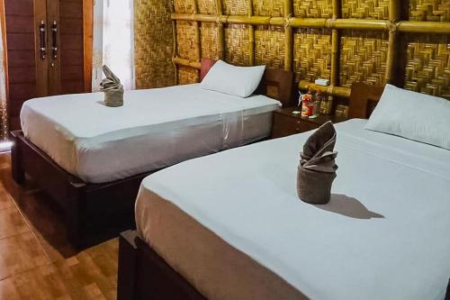 A bed or beds in a room at Villa Bambu Rinjani & Restaurant Mitra RedDoorz