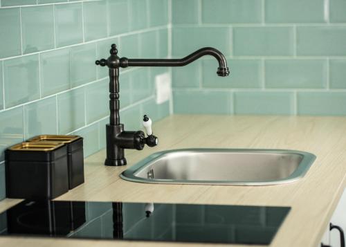 a kitchen counter with a sink and a faucet at Dusa Zlatibora in Zlatibor
