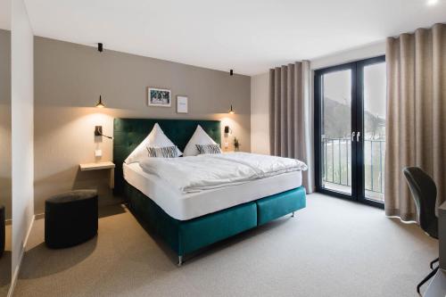 a bedroom with a large bed and a large window at Zur Alten Mühle in Lützkampen