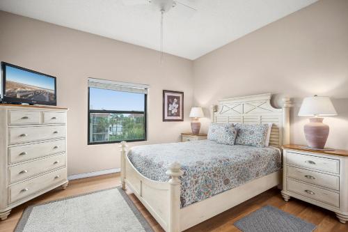 a bedroom with a bed and a dresser and a window at Ocean Village Club Q32, 2 Bedrooms, Sleeps 6, Ocean View, Pet Friendly in Butler Beach