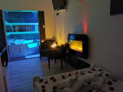 a room with a living room with a fireplace at Apartments Take a Break Novi Sad in Novi Sad