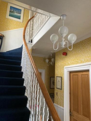 a staircase in a home with a blue and white stair at Dana Villa Holiday Accommodation in Oban