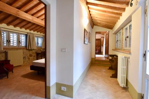 a hallway of a house with a room with a bed at Piccolo Borgo Gagnoni in Sinalunga