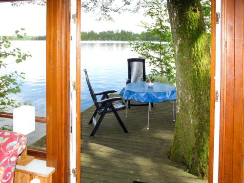 una mesa y sillas en un muelle junto al agua en Holiday Home Sjöatorp Sjöstugan by Interhome, en Hjortsberga