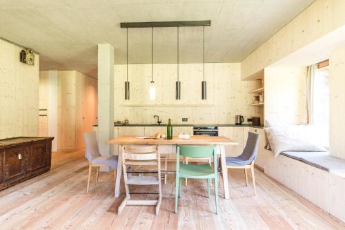 a kitchen and dining room with a table and chairs at Iselhof in Lienz