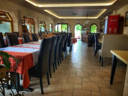 a dining room with a table and chairs at Hotel Zéta in Lenti