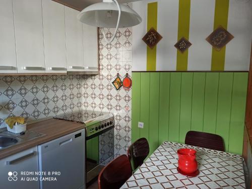 a kitchen with a table with a red mug on it at Apartment Nevela in Bovec