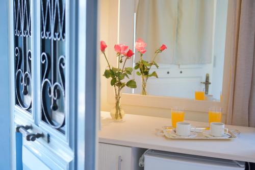 a table with two cups and a vase with flowers at Prince Studios in Sami