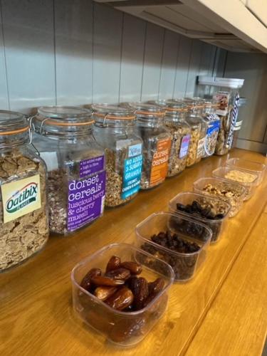 a counter topped with containers of different types of food at Prestbury Bed & Breakfast in Salisbury