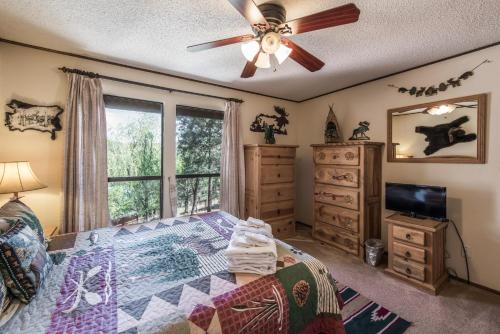 a bedroom with a bed and a ceiling fan at Cowboys, Indians and Outlaws in Ruidoso
