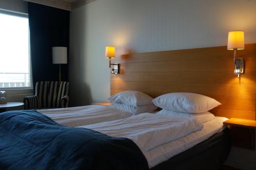 a hotel room with two beds and a headboard at Best Western Hotel Corallen in Oskarshamn