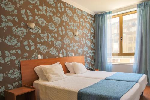 Voodi või voodid majutusasutuse Imperio Hotel toas