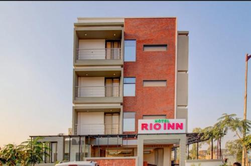 a red brick building with a rhodium sign on it at Hotel rio inn in Trimbak