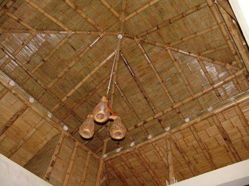 a pair of bells hanging from the ceiling of a barn at Villa Sunset Beach Peru in Los Órganos