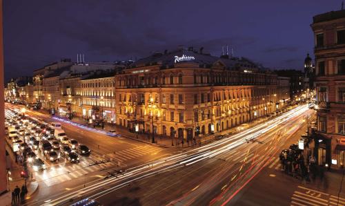 a city street at night with traffic and buildings at Radisson Royal Hotel in Saint Petersburg