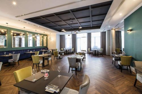 a restaurant with tables and chairs in a room at Radisson Blu Hotel Wroclaw in Wrocław