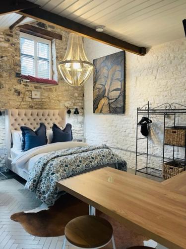 een slaapkamer met een bed en een houten tafel bij Gardener's Cwtch, Llwynhelig Manor in Llandeilo