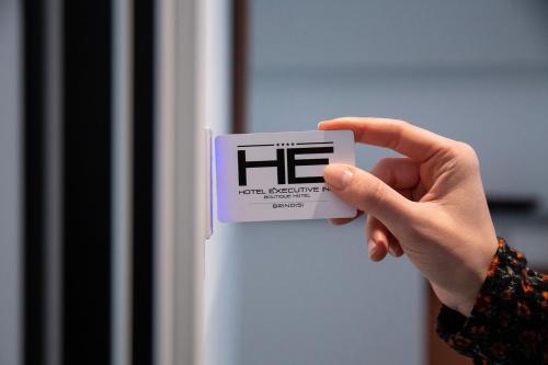 a person holding a sign with the word he on it at Executive Inn Boutique Hotel in Brindisi