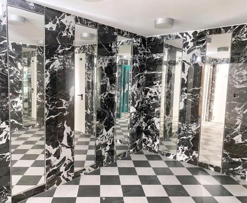 a bathroom with a black and white checkered floor at UR-NEST Donato Creti in Bologna