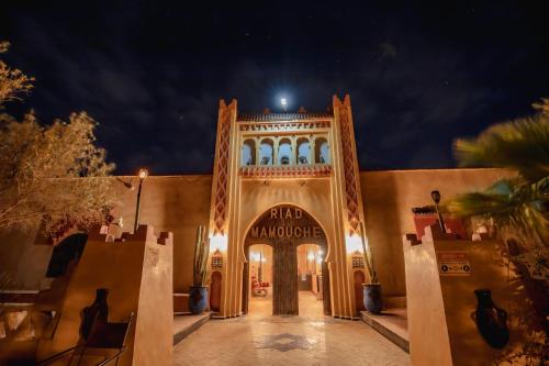 an entrance to a building at night at Riad Mamouche in Merzouga
