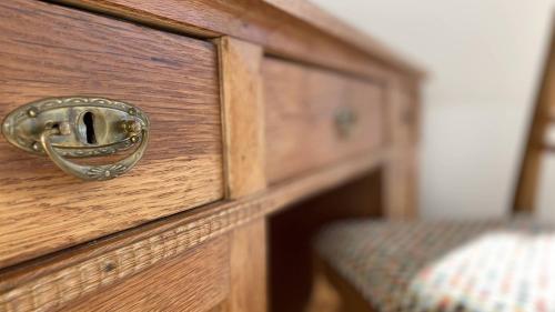a wooden drawer with a handle on a wooden dresser at Villa Søholt - Silkeborg Bed and Breakfast in Silkeborg