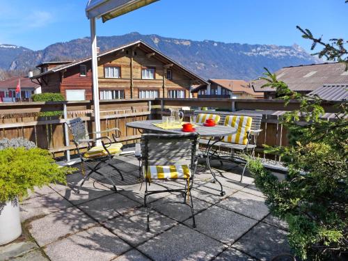 a patio with a table and chairs on a balcony at Apartment Carina 4 4 by Interhome in Wilderswil