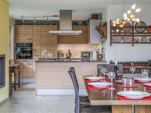 una cucina con tavolo da pranzo con piatti rossi di Apartment Carina 4 4 by Interhome a Wilderswil