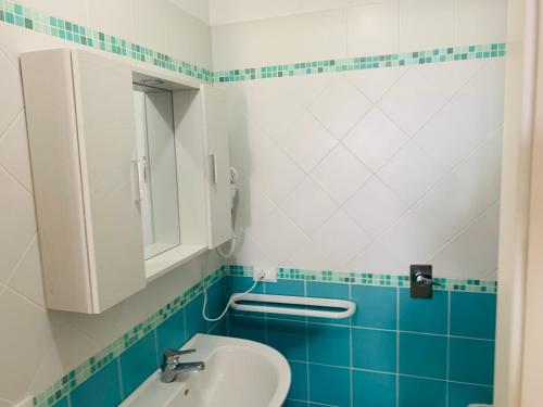 a bathroom with a sink and a mirror at Villa Ancora B&B in San Vito lo Capo