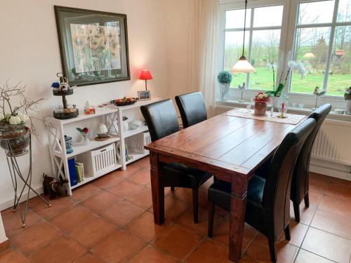 a dining room with a wooden table and chairs at Holiday Home Witten by Interhome in Moorweg