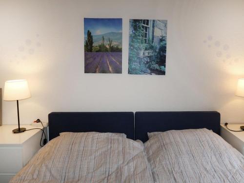 a bedroom with a bed with two pictures on the wall at Apartment Martin by Interhome in Frankenau