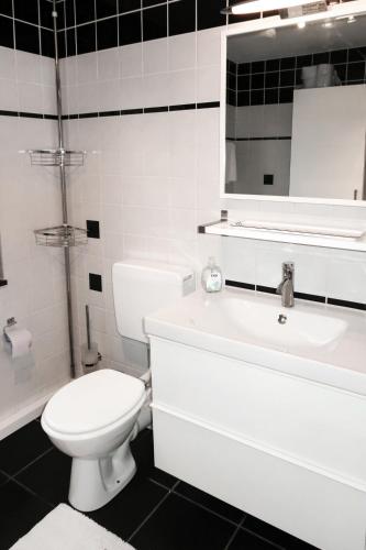 a white bathroom with a toilet and a sink at Apartment Martin by Interhome in Frankenau
