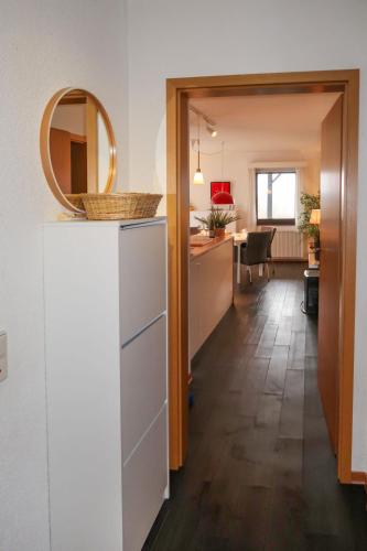 a kitchen and dining room with a mirror on top of a refrigerator at Apartment Martin by Interhome in Frankenau