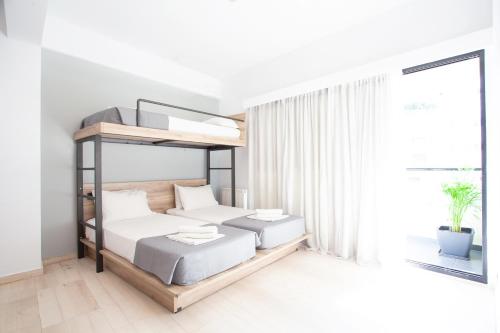 a bedroom with two bunk beds and a window at Athens Studios in Athens