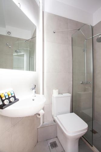 a bathroom with a toilet and a sink and a shower at Athens Studios in Athens