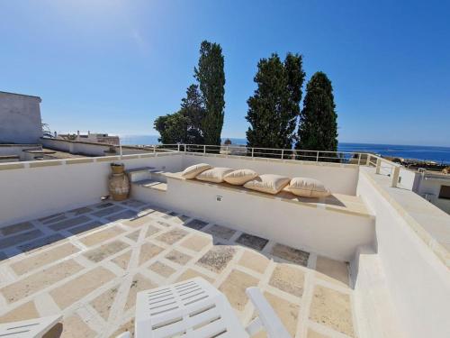 a patio with two white chairs on a roof at Apartment La Chicca by Interhome in Santa Cesarea Terme