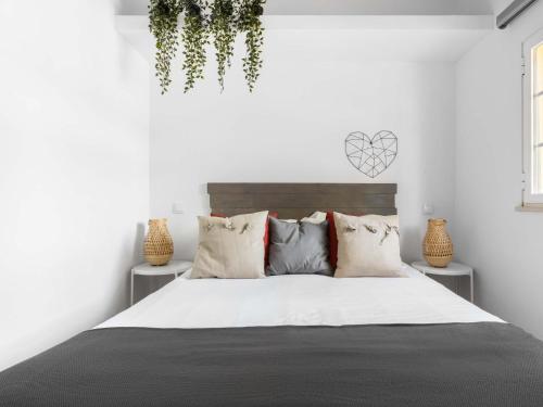 a white bedroom with a large bed with pillows at Holiday Home Quinta de Santa Emilia 2 by Interhome in São Martinho