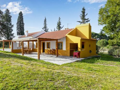 a yellow house with a yard at Holiday Home Quinta de Santa Emilia 1 by Interhome in São Martinho