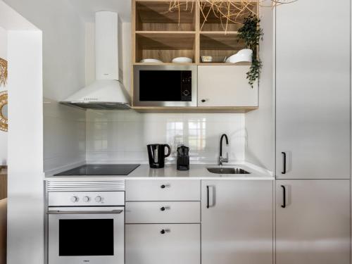 a kitchen with white cabinets and a sink at Holiday Home Quinta de Santa Emilia 1 by Interhome in São Martinho
