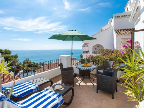 a patio with a table and chairs and an umbrella at Apartment Vista del Mar by Interhome in Nerja
