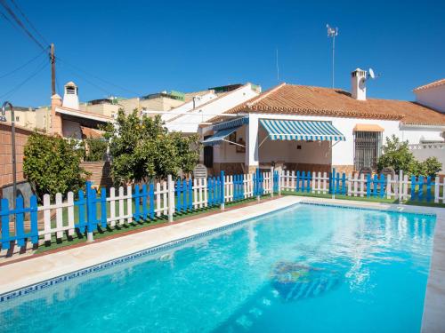 a swimming pool in front of a blue fence at Holiday Home Villa Anita by Interhome in Rincón de la Victoria