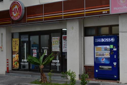 a store with a soda machine in front of it at GEORGE HOUSE in Tsuji in Naha