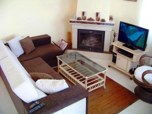 a living room with a couch and a tv at Villa Villa Roberto by Interhome in Miami Platja
