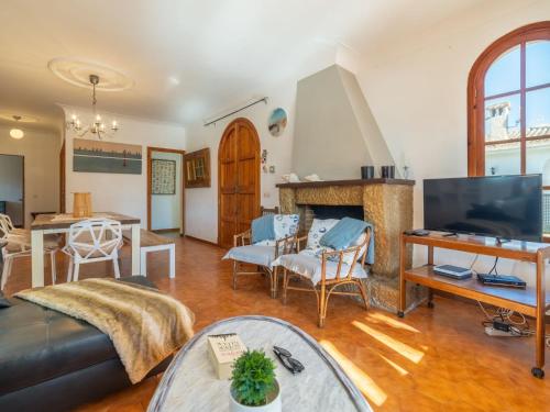 a living room with a couch and a fireplace at Holiday Home Can Xiroia by Interhome in Alcudia