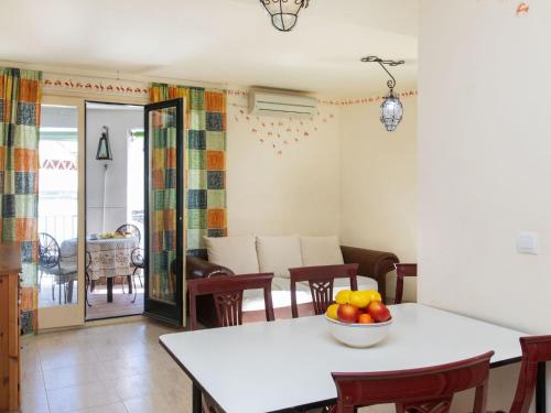 ein Esszimmer mit einem Tisch und einer Obstschale darauf in der Unterkunft Apartment Mitsu by Interhome in Tossa de Mar